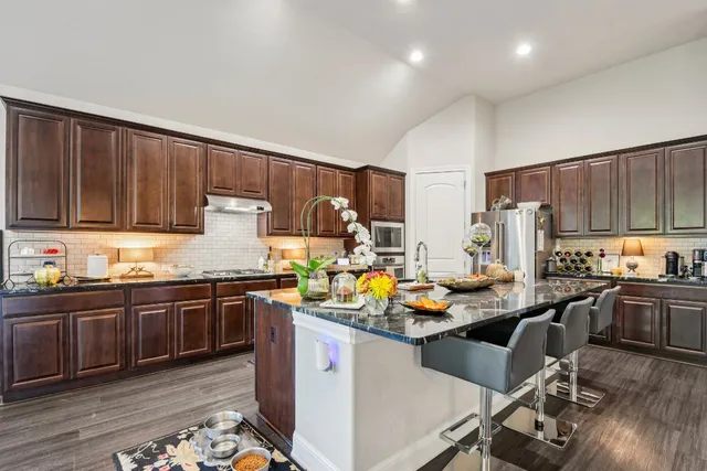 a kitchen with granite countertop lots of counter top space and stainless steel appliances