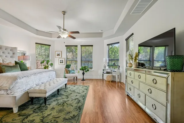 a living room with furniture fireplace and large windows