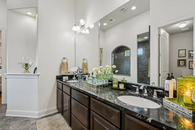 a bathroom with a double vanity sink and a mirror