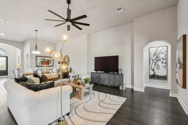 a living room with furniture a window and a flat screen tv