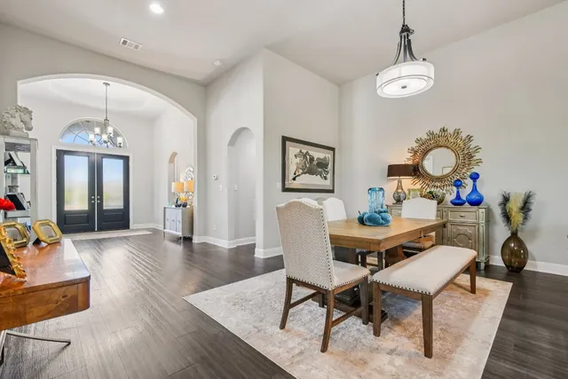 a view of a dining room with furniture and chandelier
