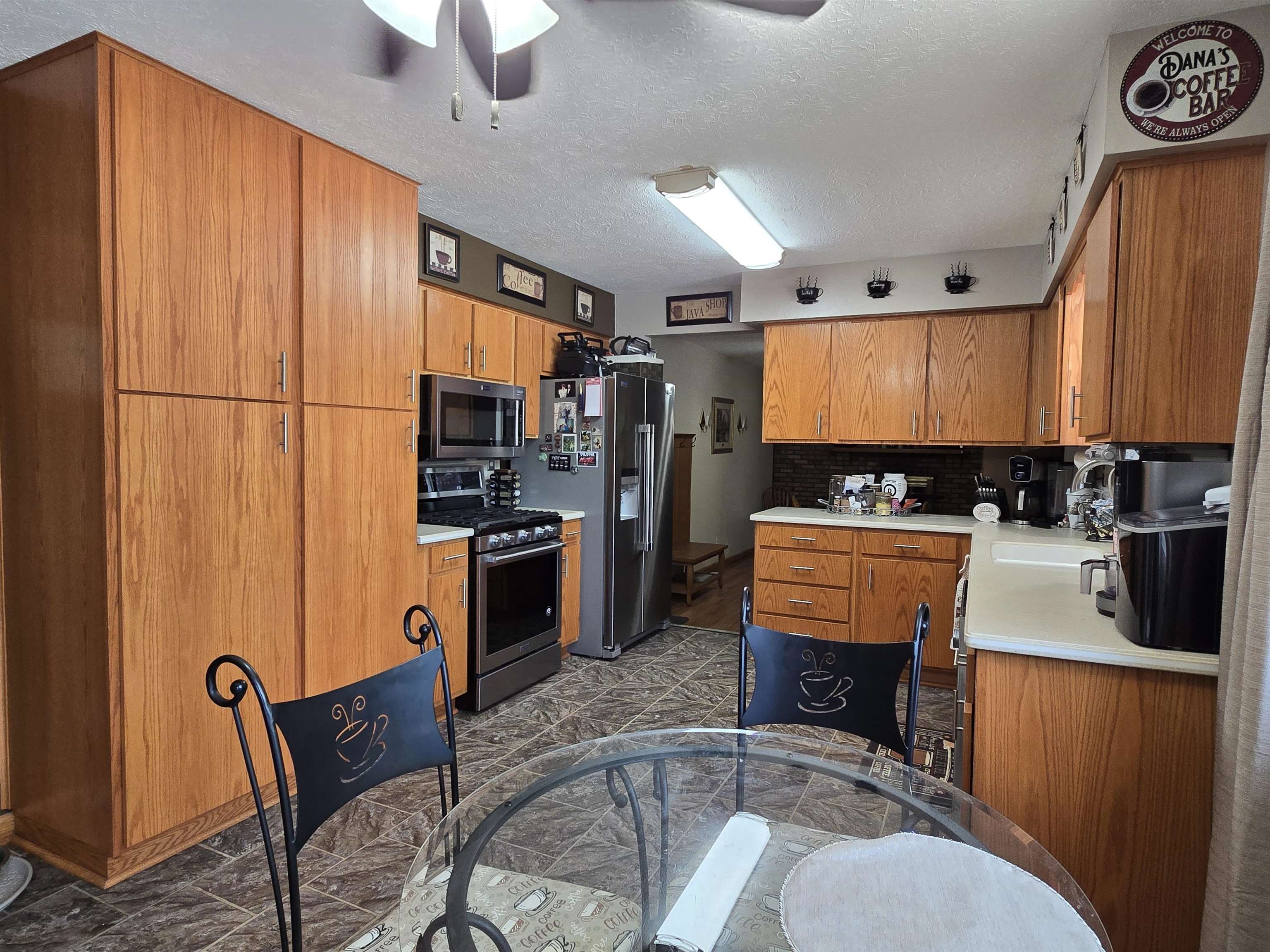 11680 Bend River Road Roscoe, IL 61073 - Photo 19 of 47 a kitchen with stainless steel appliances granite countertop a stove refrigerator sink and cabinets