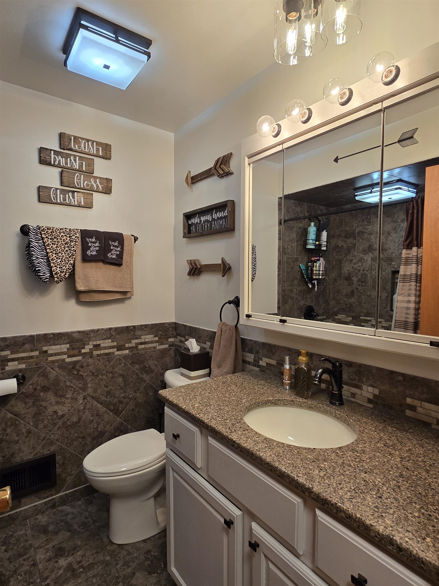 11680 Bend River Road Roscoe, IL 61073 - Photo 32 of 47 a bathroom with a granite countertop toilet sink and mirror