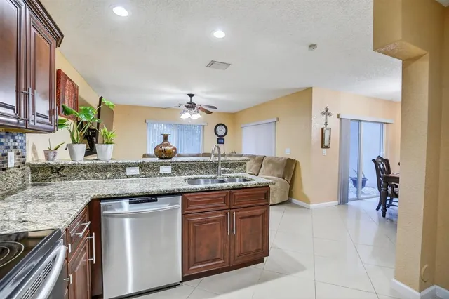 a kitchen with a sink and a refrigerator