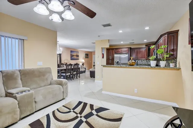 a living room with furniture and kitchen view