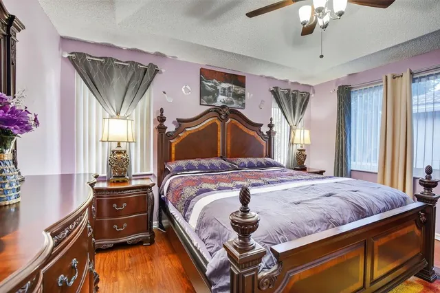 a bedroom with a bed and dresser with window