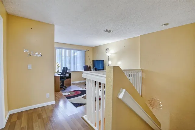 a view of a livingroom with furniture and a flat screen tv