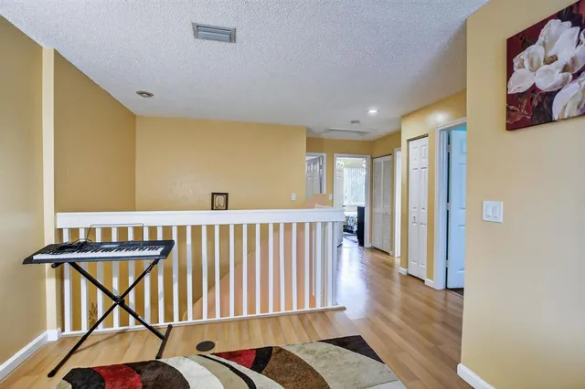 a view of a hallway with furniture and a window