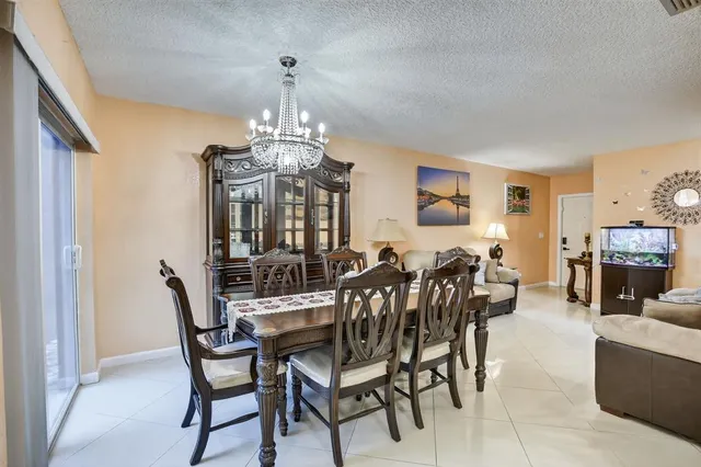 a view of a dining room with furniture and chandelier