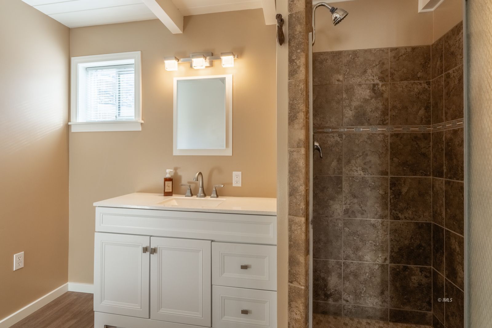 317 West Main Street Independence, CA 93526 - Photo 14 of 33 a bathroom with a sink a vanity a shower and a mirror