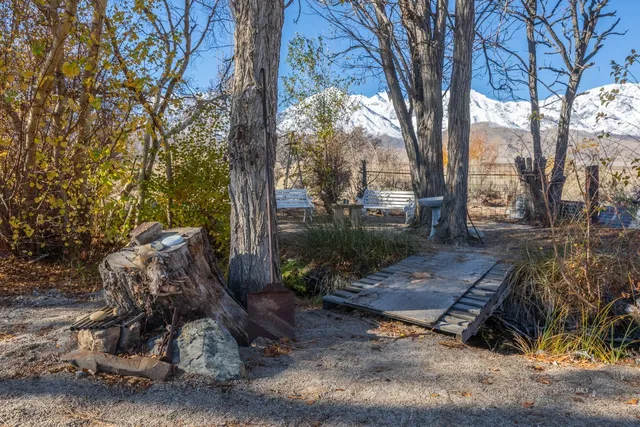 an aerial view of a house with a mountain