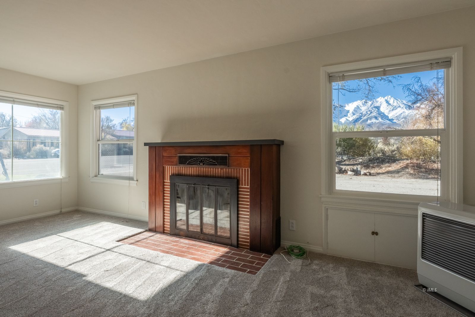 317 West Main Street Independence, CA 93526 - Photo 3 of 33 a view of an empty room with a window and wooden floor