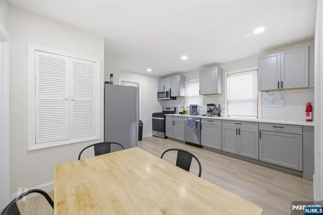 a kitchen with a refrigerator sink and cabinets