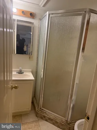 a bathroom with sink a mirror and shower