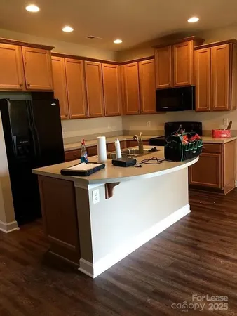 a kitchen with stainless steel appliances wooden cabinets and a refrigerator