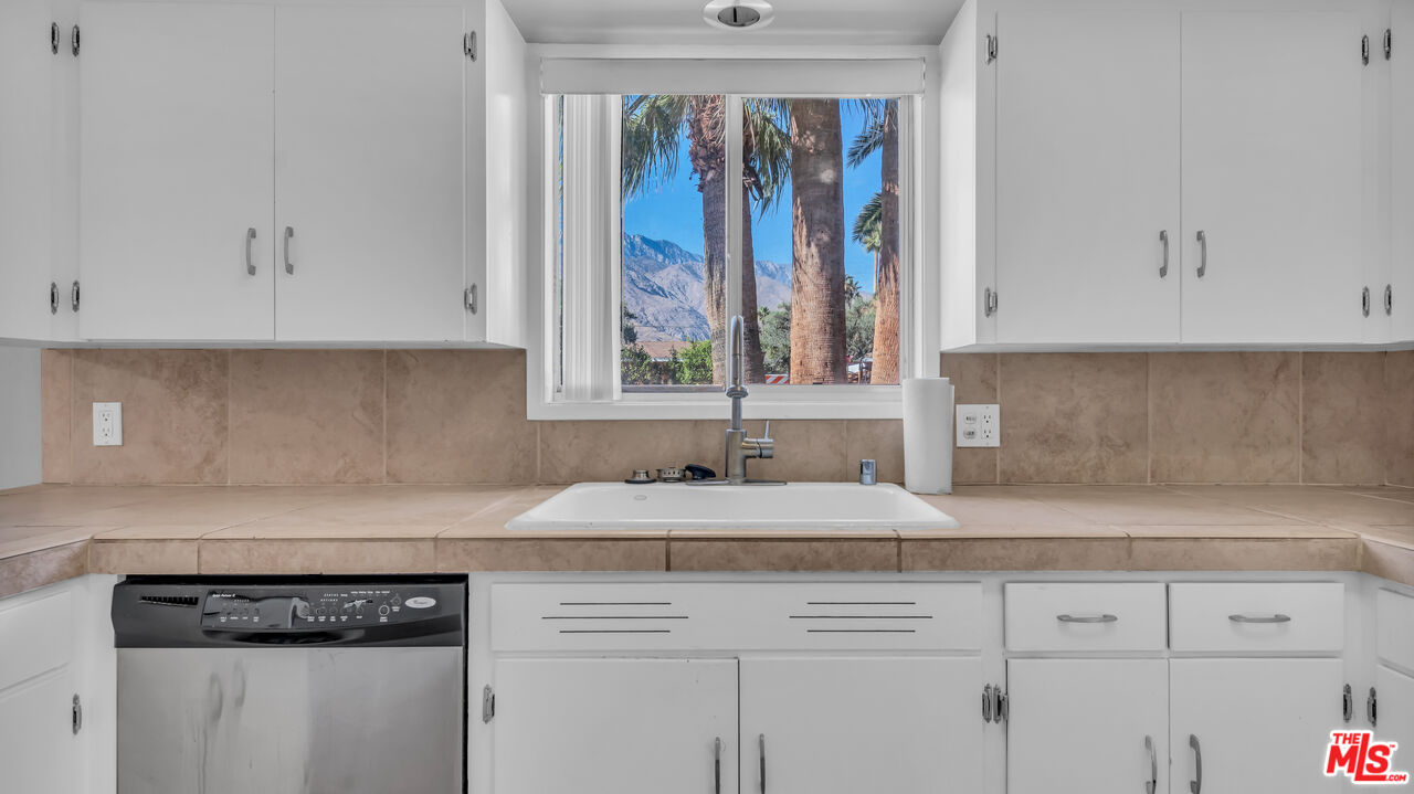 494 North Monterey Road Palm Springs, CA 92262 - Photo 13 of 30 a kitchen with granite countertop a sink and a window