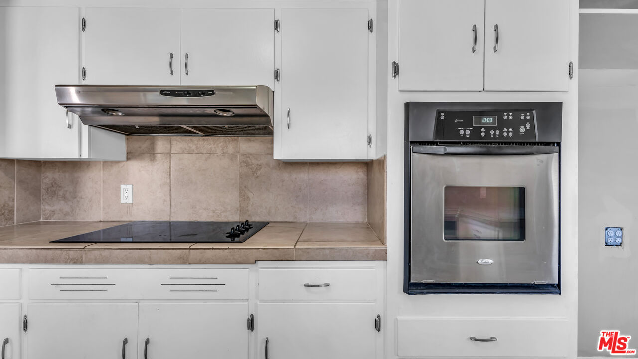 494 North Monterey Road Palm Springs, CA 92262 - Photo 15 of 30 a kitchen with stainless steel appliances granite countertop a stove and a microwave oven