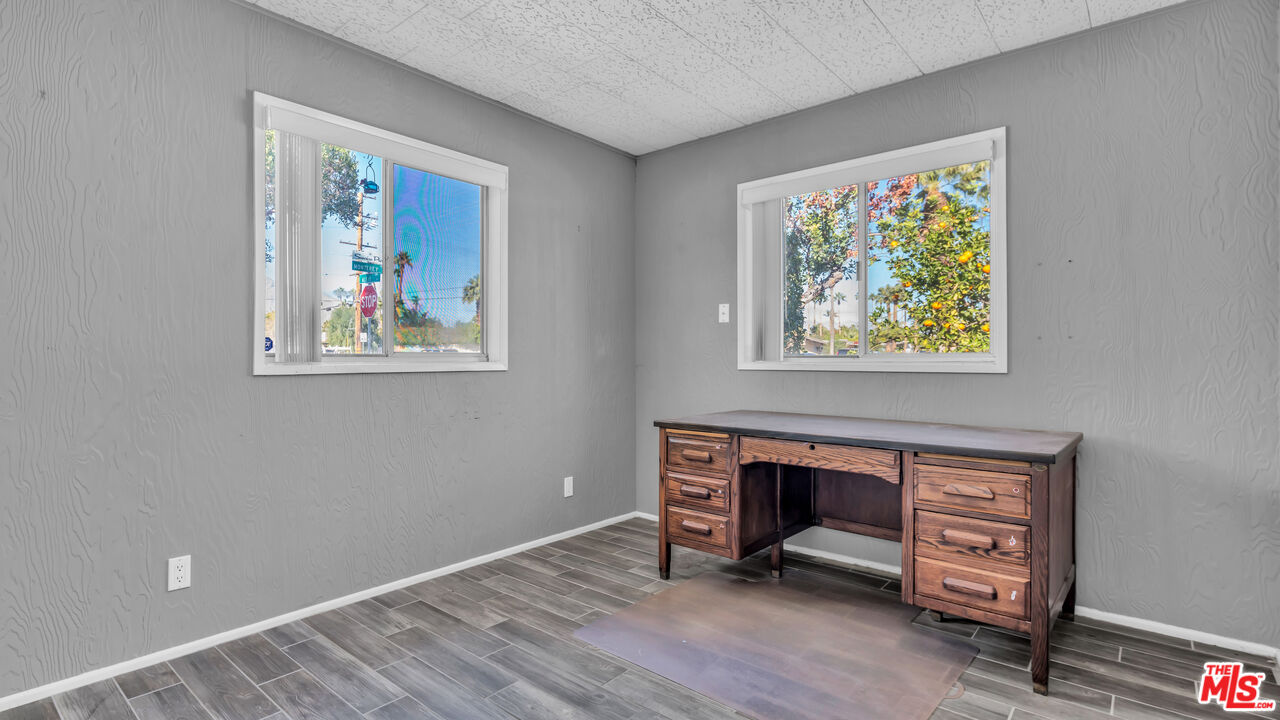 494 North Monterey Road Palm Springs, CA 92262 - Photo 16 of 30 a view of an empty room with window and wooden floor