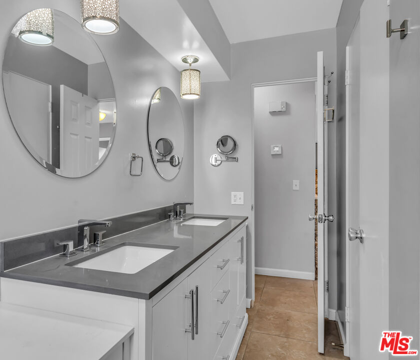 494 North Monterey Road Palm Springs, CA 92262 - Photo 19 of 30 a bathroom with a granite countertop double vanity sink and a mirror