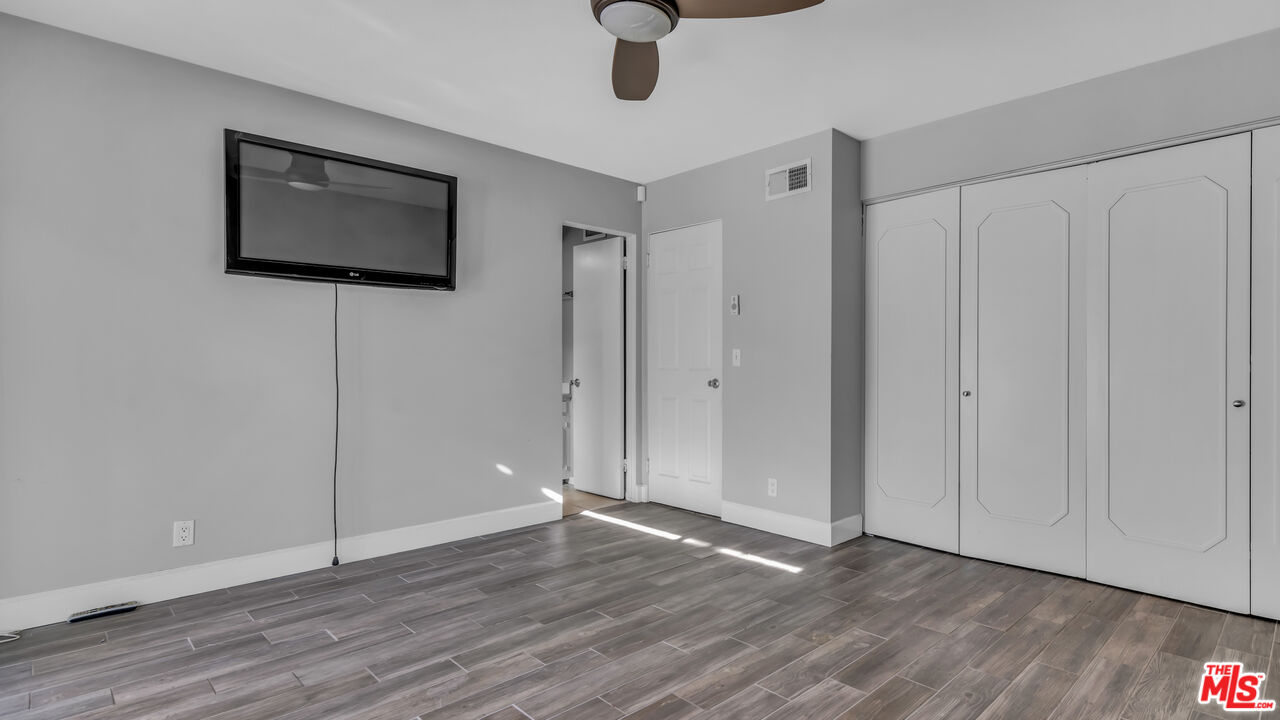 494 North Monterey Road Palm Springs, CA 92262 - Photo 24 of 30 a view of an empty room with wooden floor and cabinet