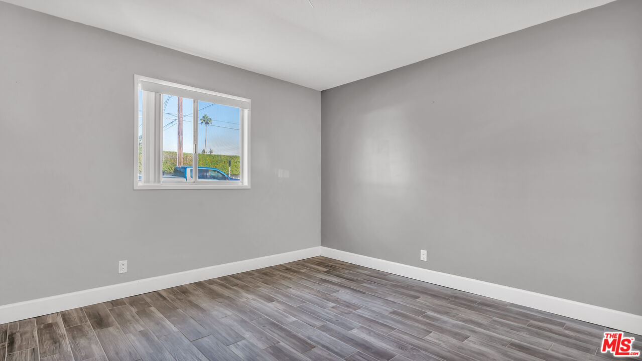 494 North Monterey Road Palm Springs, CA 92262 - Photo 26 of 30 a view of an empty room with wooden floor and a window