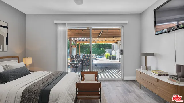 a bedroom with a bed and a wooden floor