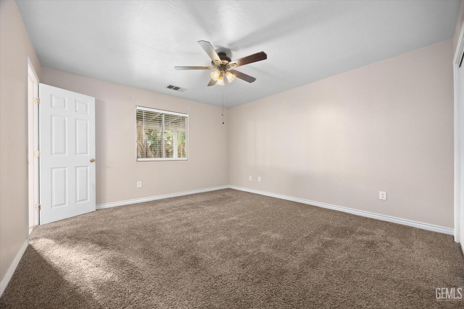 Undisclosed Address Bakersfield, CA 93312 - Photo 21 of 38 an empty room with windows and fan
