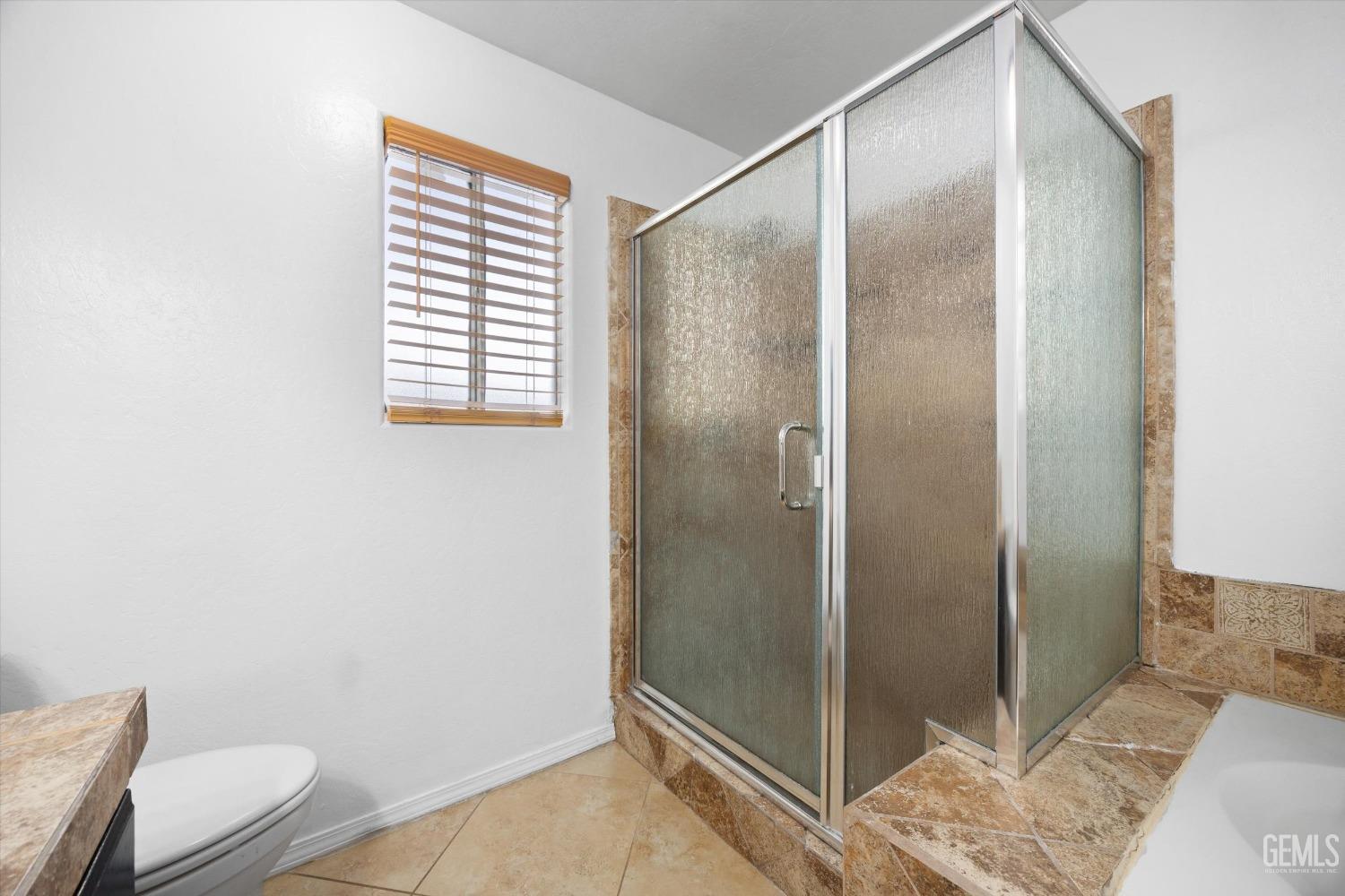 Undisclosed Address Bakersfield, CA 93312 - Photo 25 of 38 a bathroom with a shower and toilet