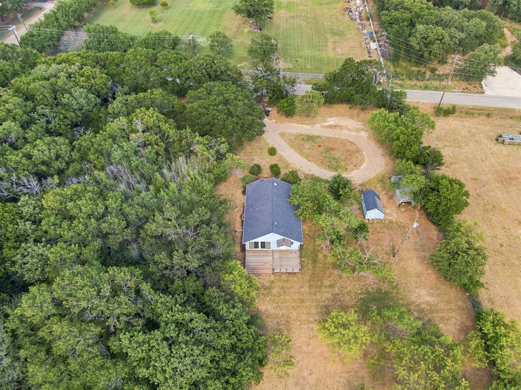 3325 Dove Creek Road Cleburne, TX 76031 - Photo 2 of 40 Residential property featuring a dark-pitched roof, light-colored siding, and a rear deck