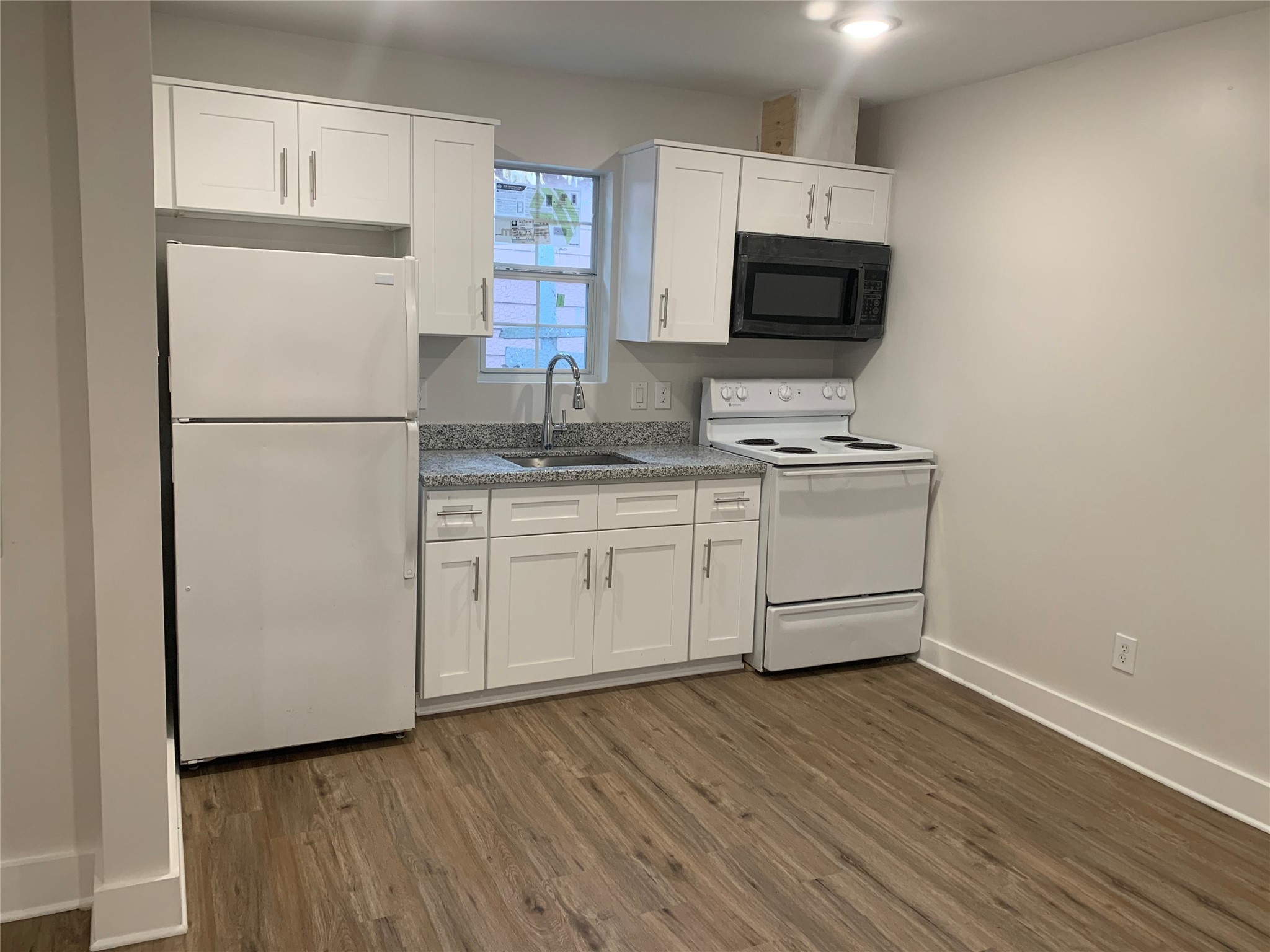 548 Majestic Street, Unit R Houston, TX 77020 - Photo 4 of 6 a kitchen with stainless steel appliances a refrigerator sink and microwave