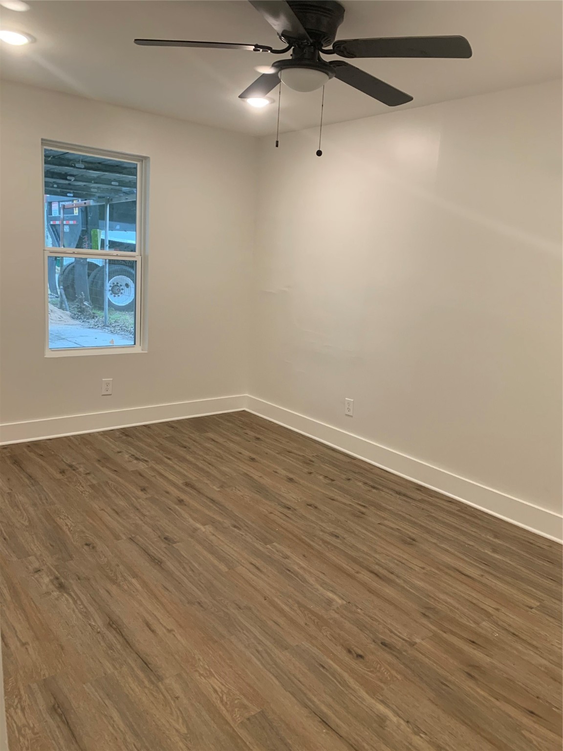 548 Majestic Street, Unit R Houston, TX 77020 - Photo 5 of 6 an empty room with wooden floor and windows