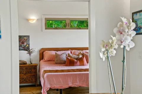 a bedroom with a large bed and a window