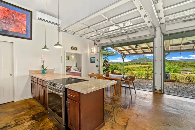 a kitchen with stainless steel appliances granite countertop a sink and a table