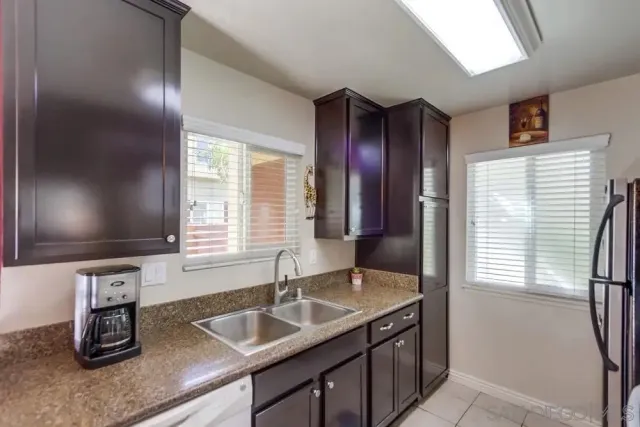 a bathroom with a granite countertop sink and a large mirror