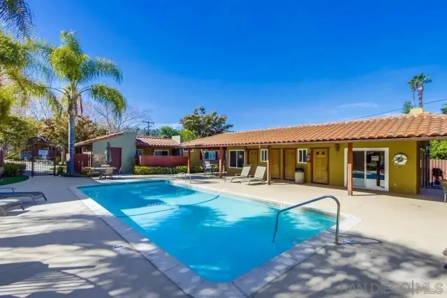 a view of a house with swimming pool and a porch