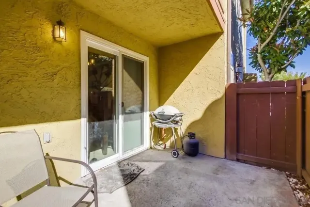 a view of a patio with table and chairs and potted plants