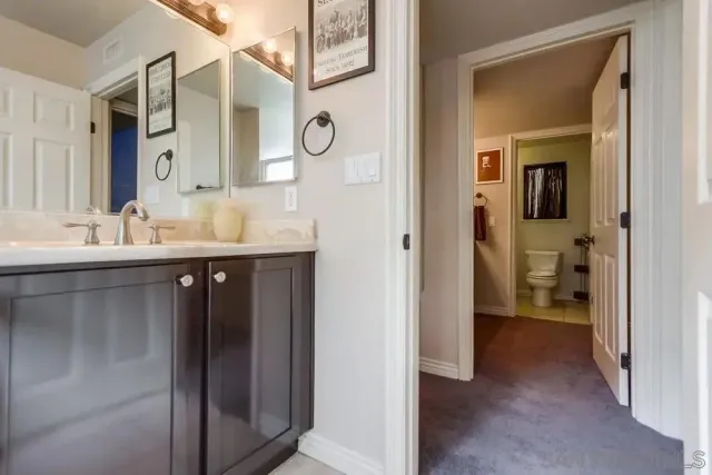 a en suite bathroom with a sink and a mirror