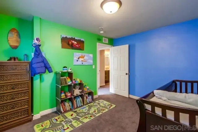 a room with furniture and a painting on the wall