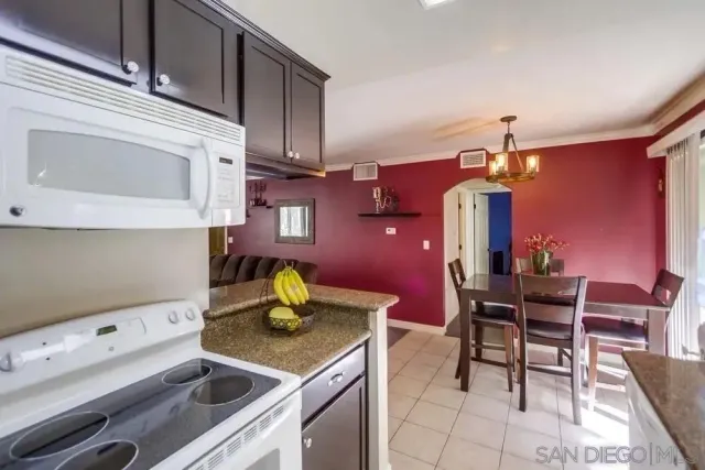 a kitchen with a cabinets and chairs