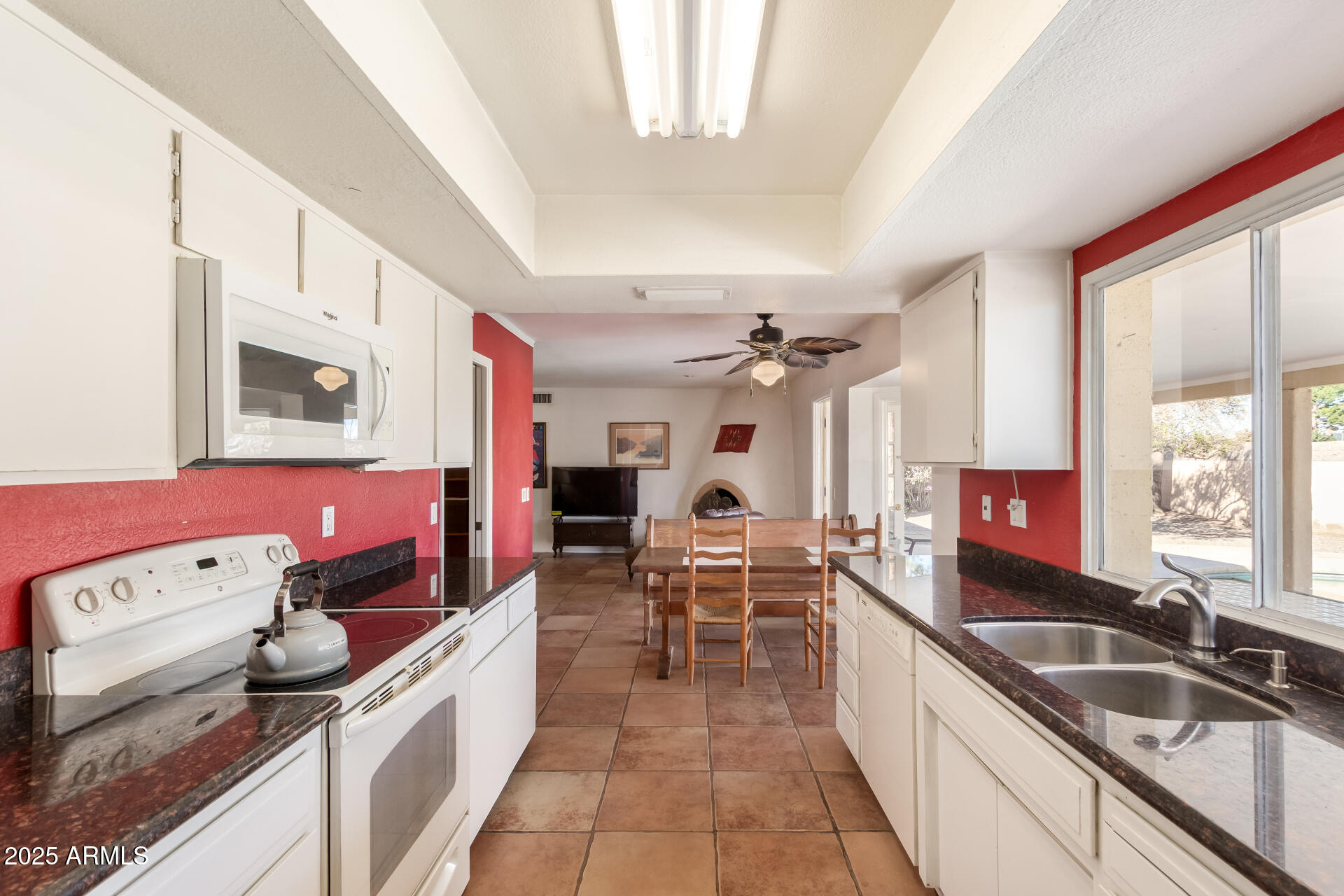 1220 East Julie Drive Tempe, AZ 85283 - Photo 11 of 32 a large kitchen with a large window and stainless steel appliances