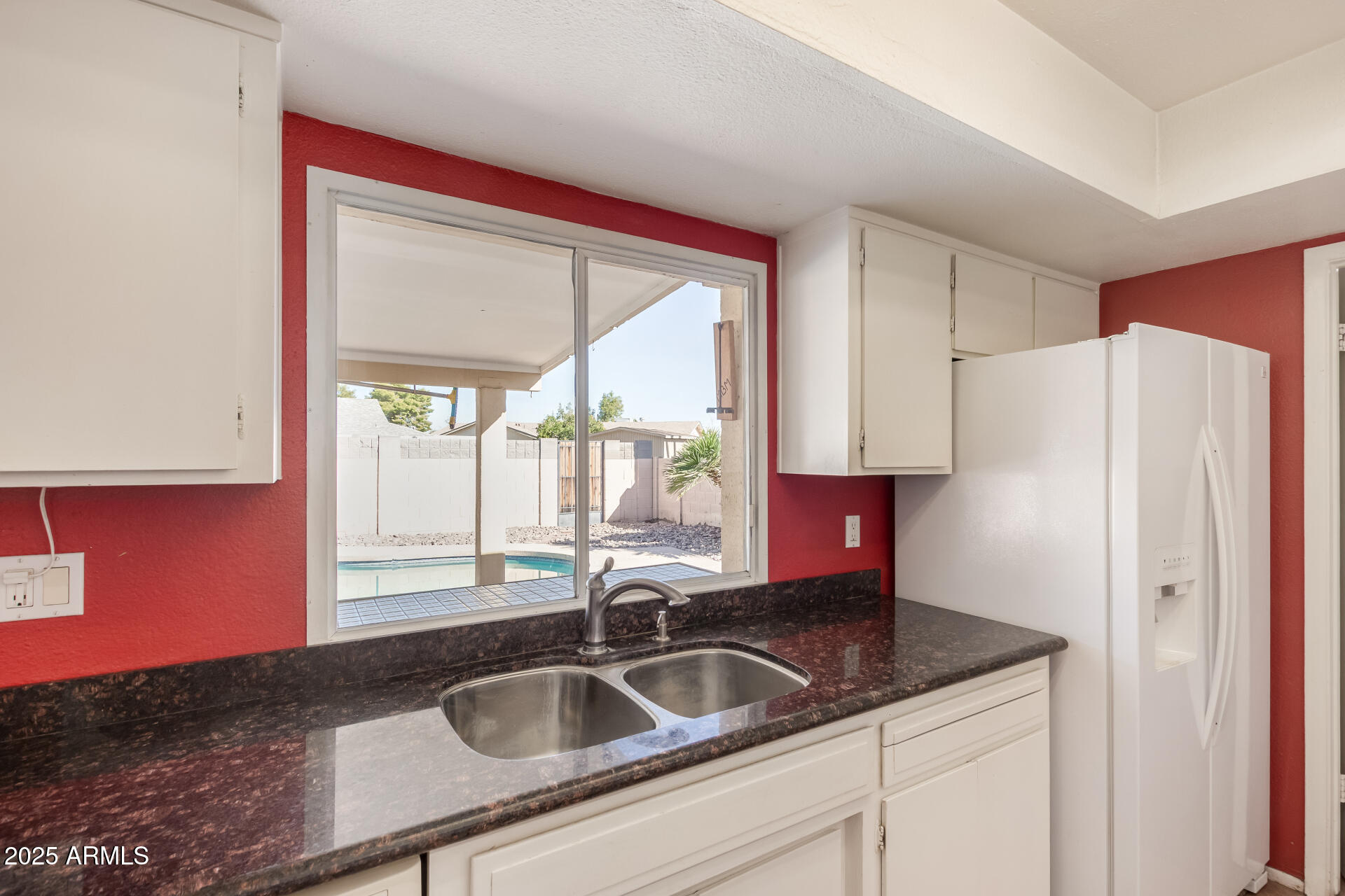 1220 East Julie Drive Tempe, AZ 85283 - Photo 12 of 32 a kitchen with granite countertop a sink and a refrigerator