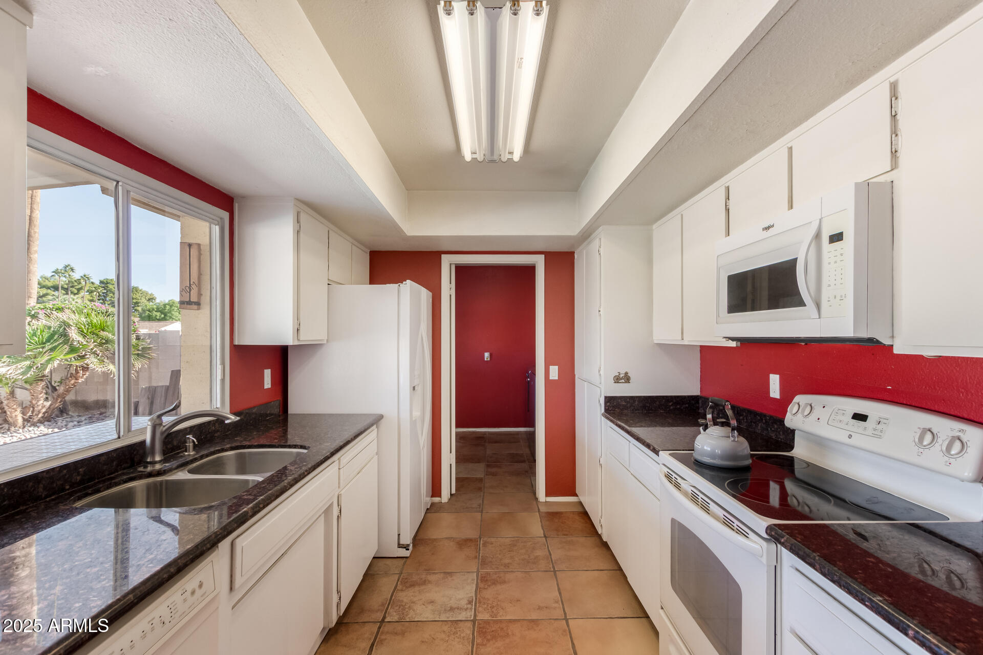 1220 East Julie Drive Tempe, AZ 85283 - Photo 13 of 32 a kitchen with stainless steel appliances granite countertop a sink stove and refrigerator