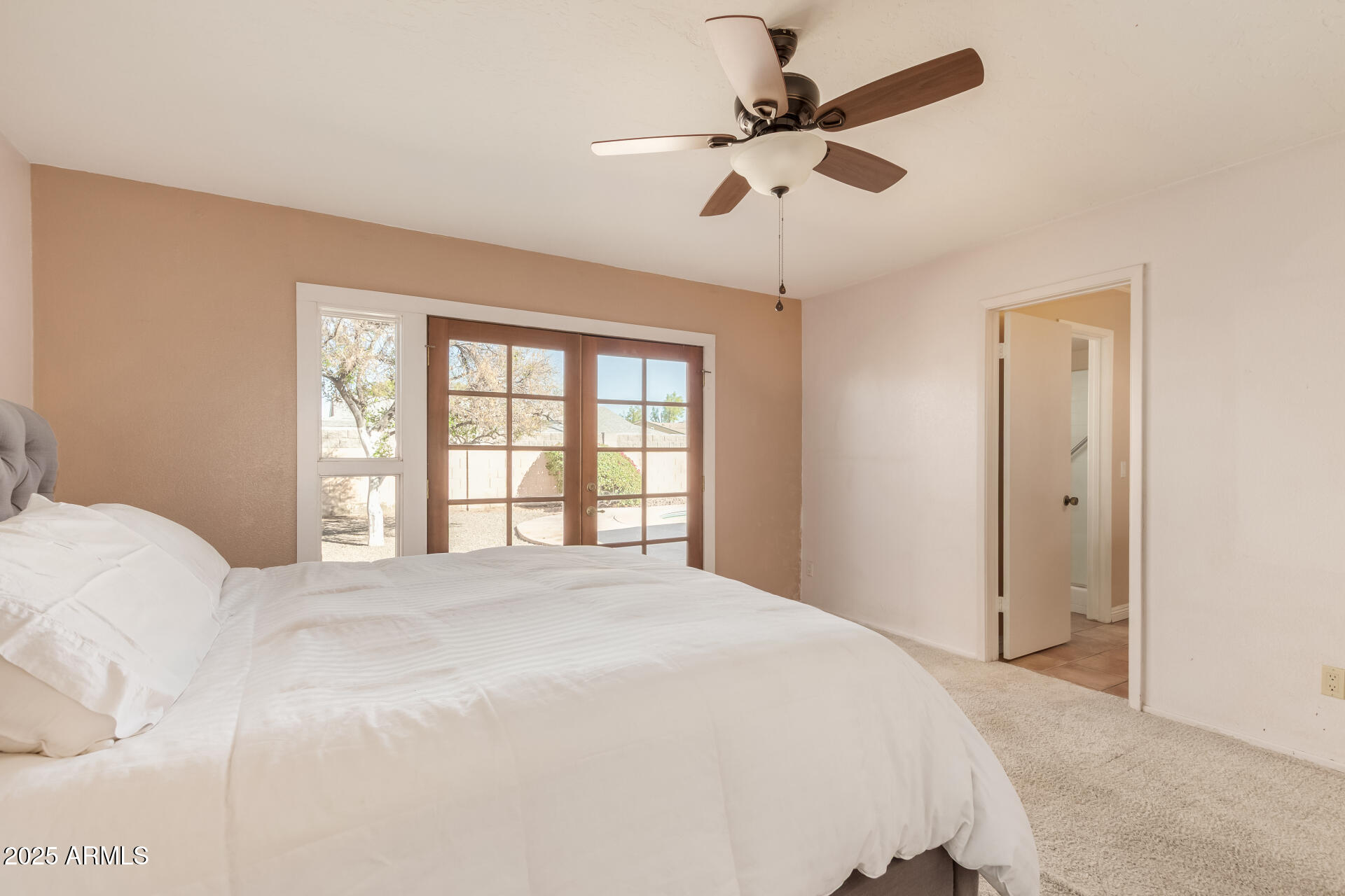 1220 East Julie Drive Tempe, AZ 85283 - Photo 15 of 32 a bedroom with a large bed and a large window