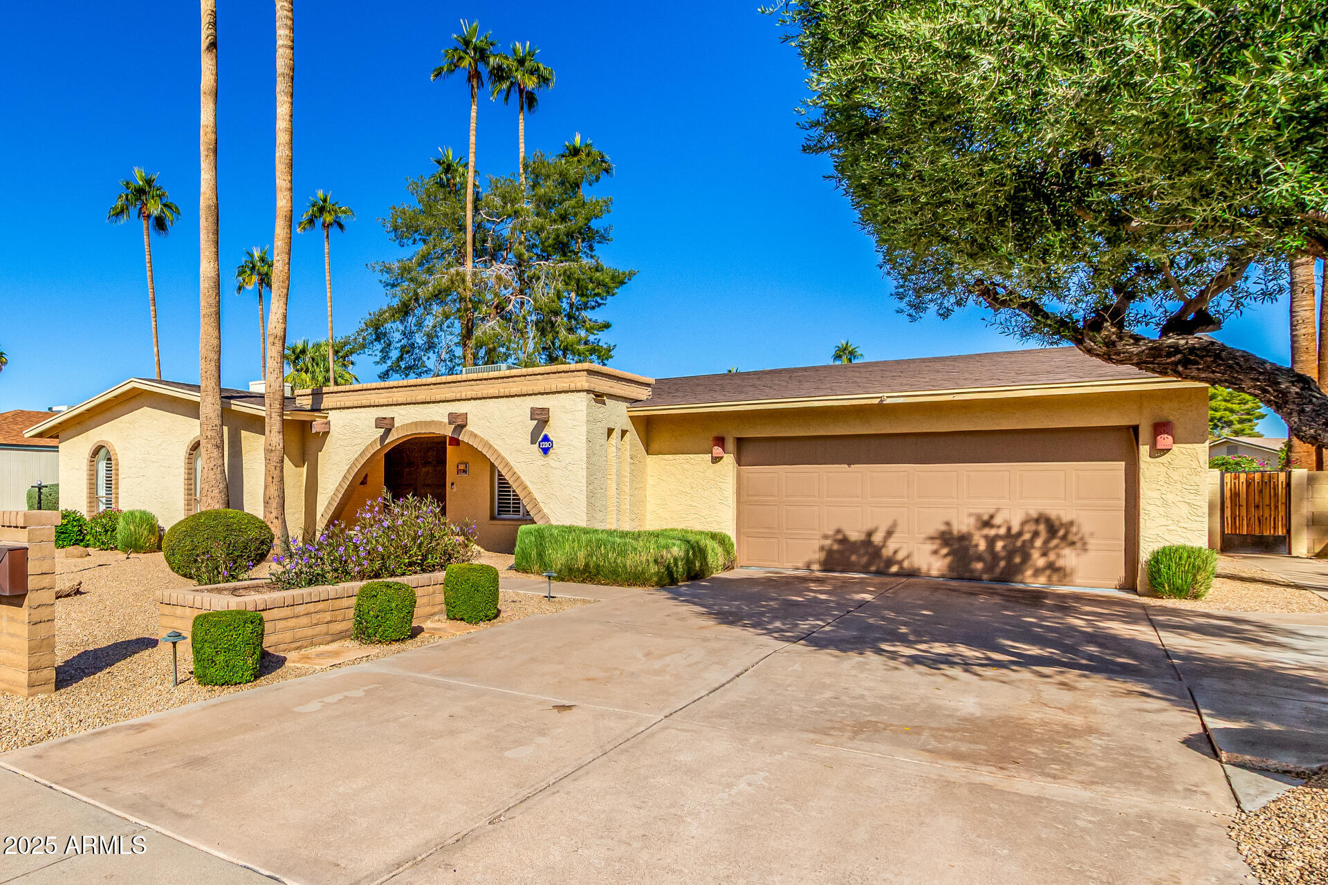 1220 East Julie Drive Tempe, AZ 85283 - Photo 4 of 32 a front view of a house with a yard and garage