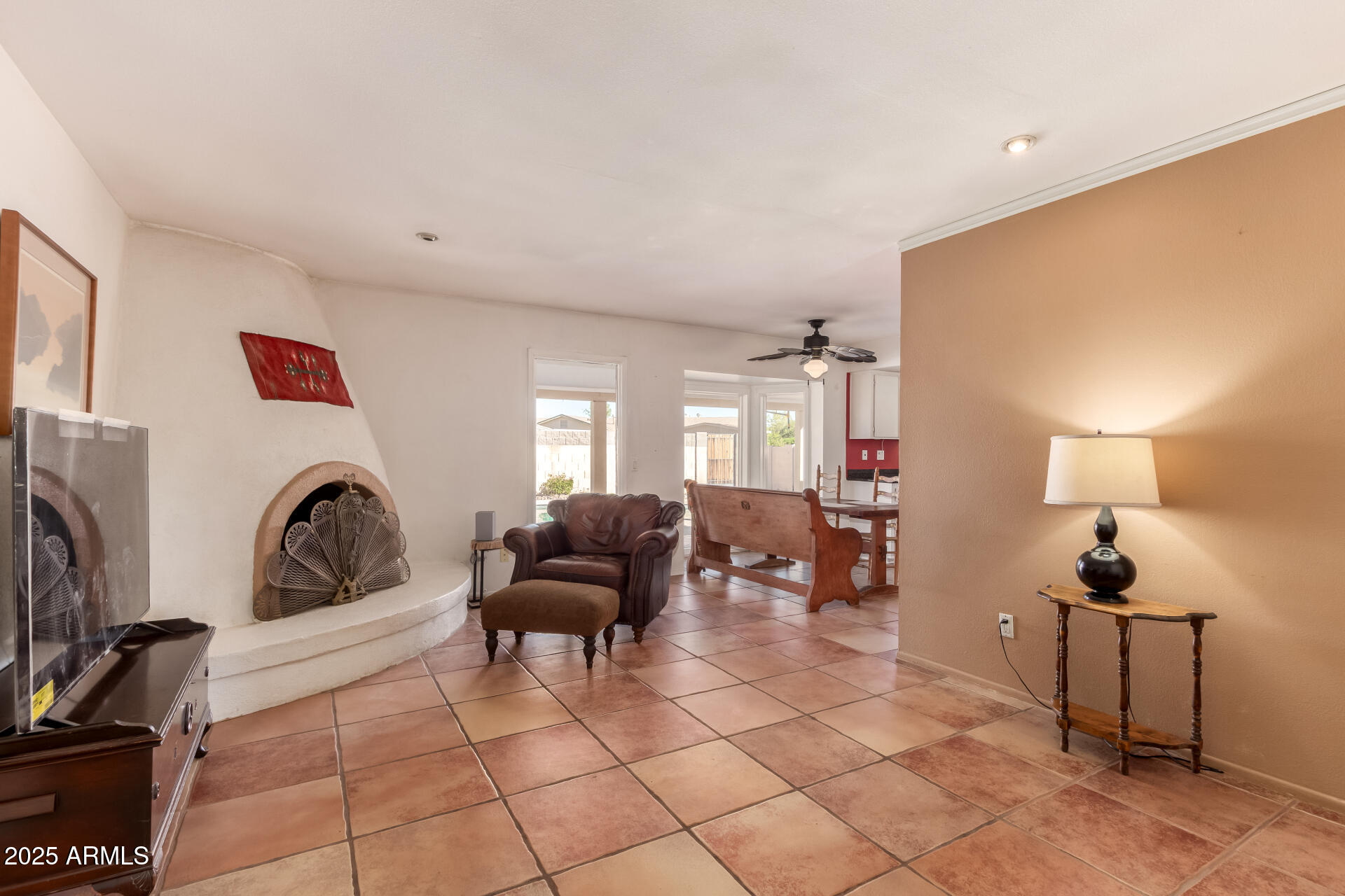 1220 East Julie Drive Tempe, AZ 85283 - Photo 8 of 32 a living room with furniture a fireplace and a floor to ceiling window