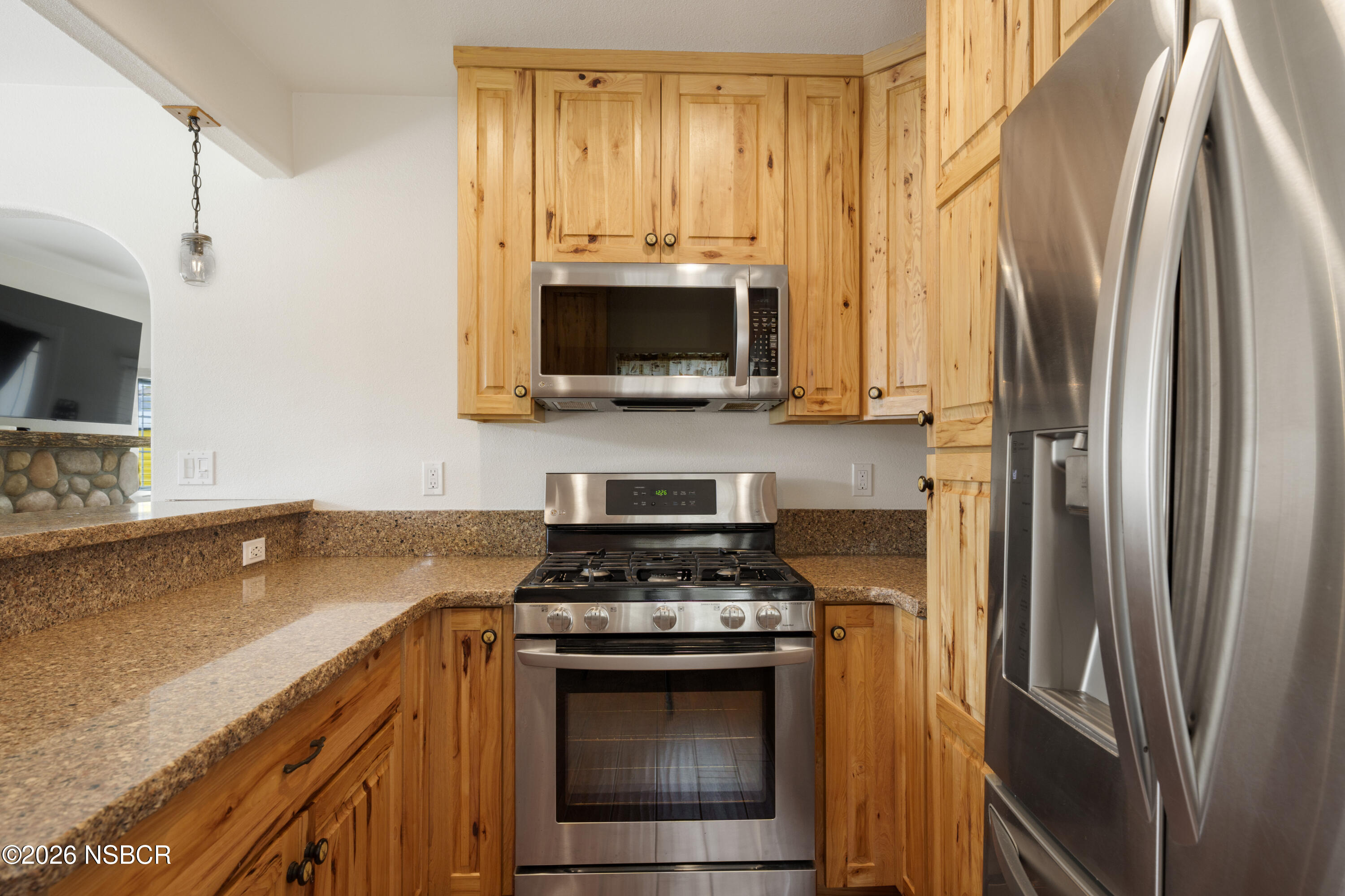 138 North E Street Lompoc, CA 93436 - Photo 13 of 35 a kitchen with stainless steel appliances a stove microwave and a refrigerator