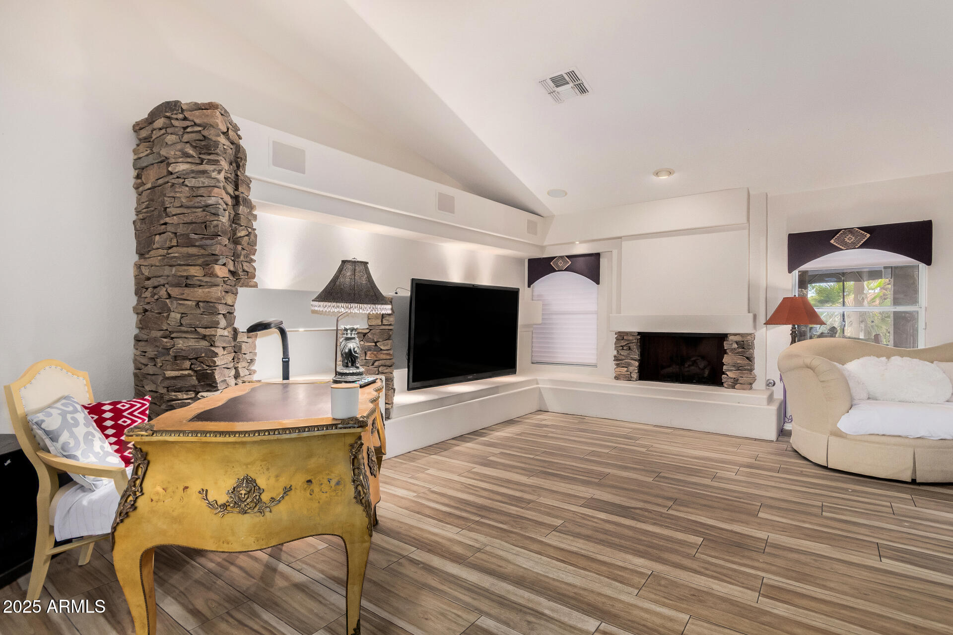 15531 Piccadilly Road Goodyear, AZ 85395 - Photo 15 of 54 a living room with furniture and a fireplace