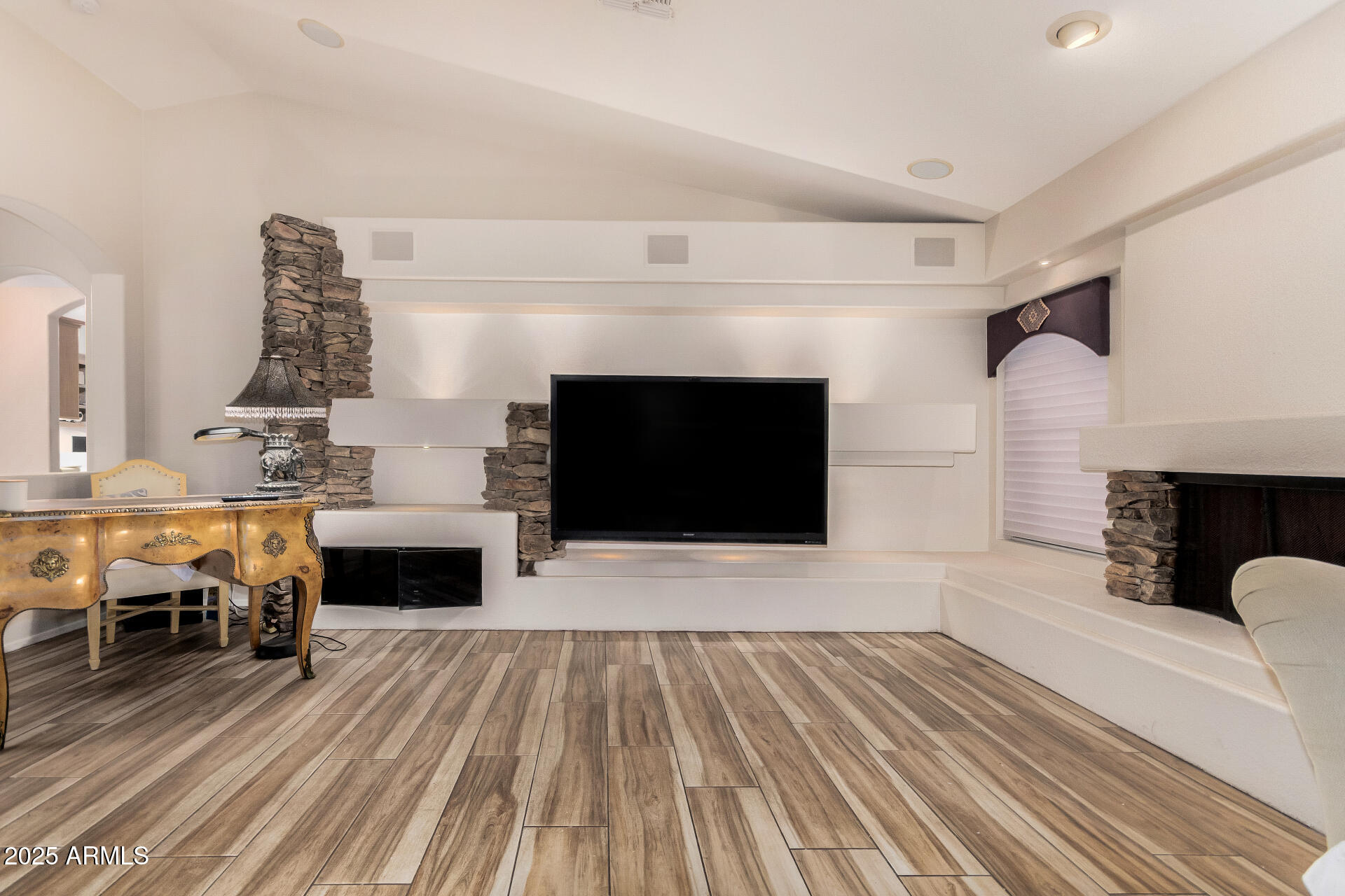 15531 Piccadilly Road Goodyear, AZ 85395 - Photo 17 of 54 a living room with furniture a fireplace and a flat screen tv