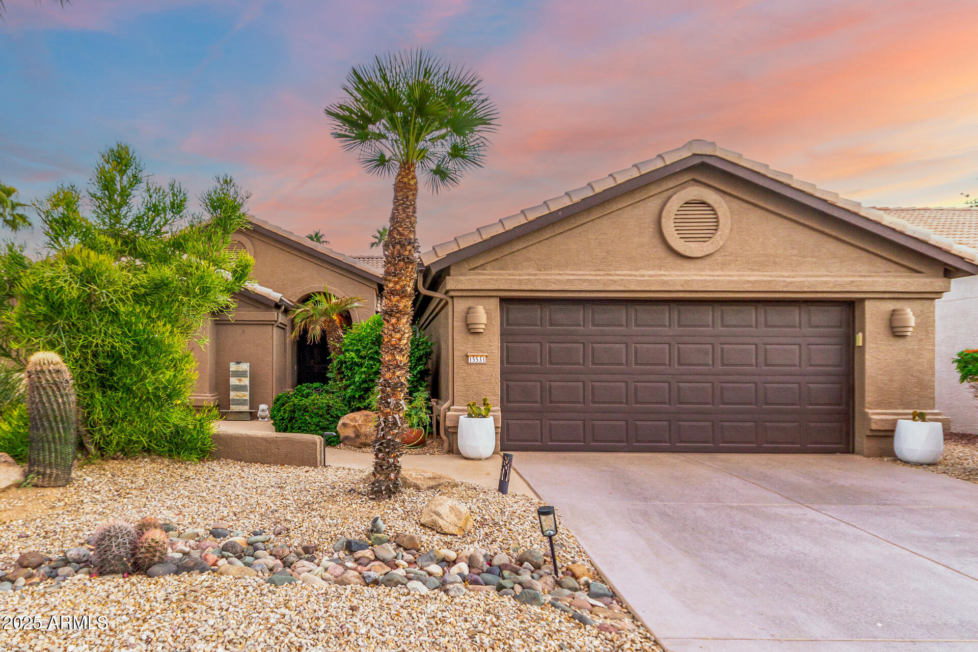 15531 Piccadilly Road Goodyear, AZ 85395 - Photo 2 of 54 a front view of a house with a yard and garage