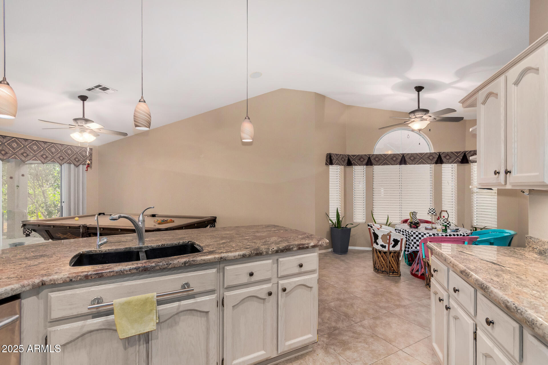 15531 Piccadilly Road Goodyear, AZ 85395 - Photo 27 of 54 a kitchen with stainless steel appliances granite countertop a sink a counter space and cabinets